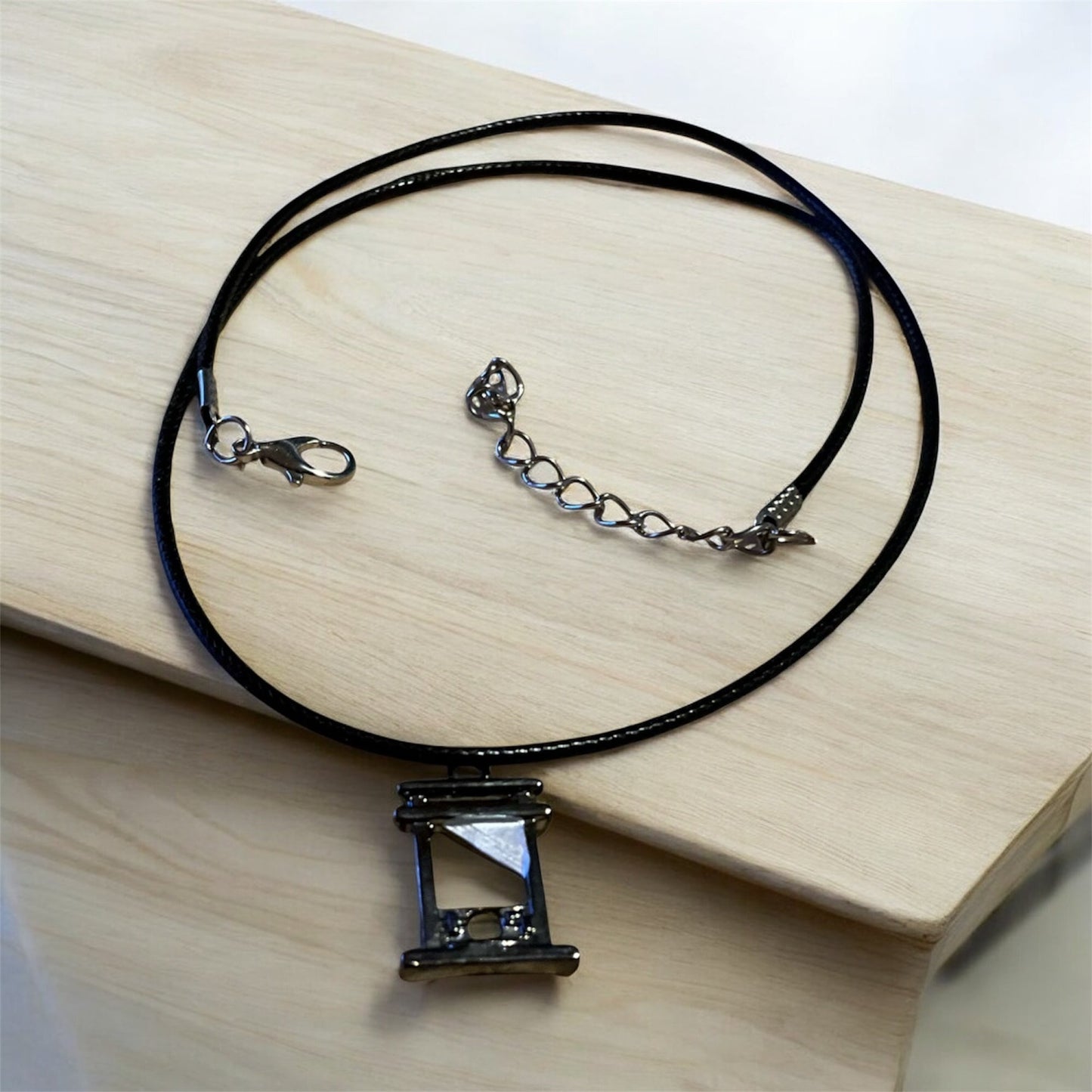 Guillotine pendant with black necklace