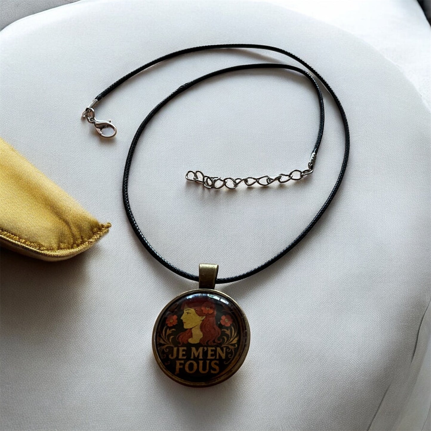 Cheeky “Je m’en fous” pendant with black cord necklace