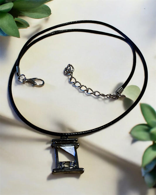Guillotine pendant with black necklace