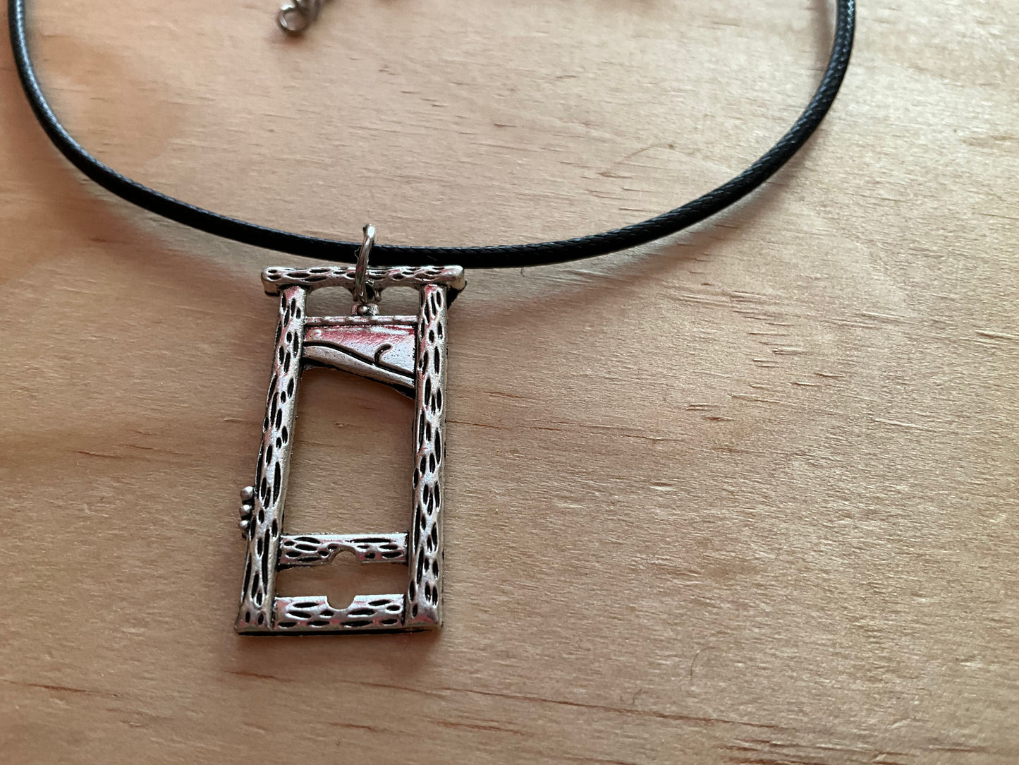 Silver plated guillotine pendant with black necklace