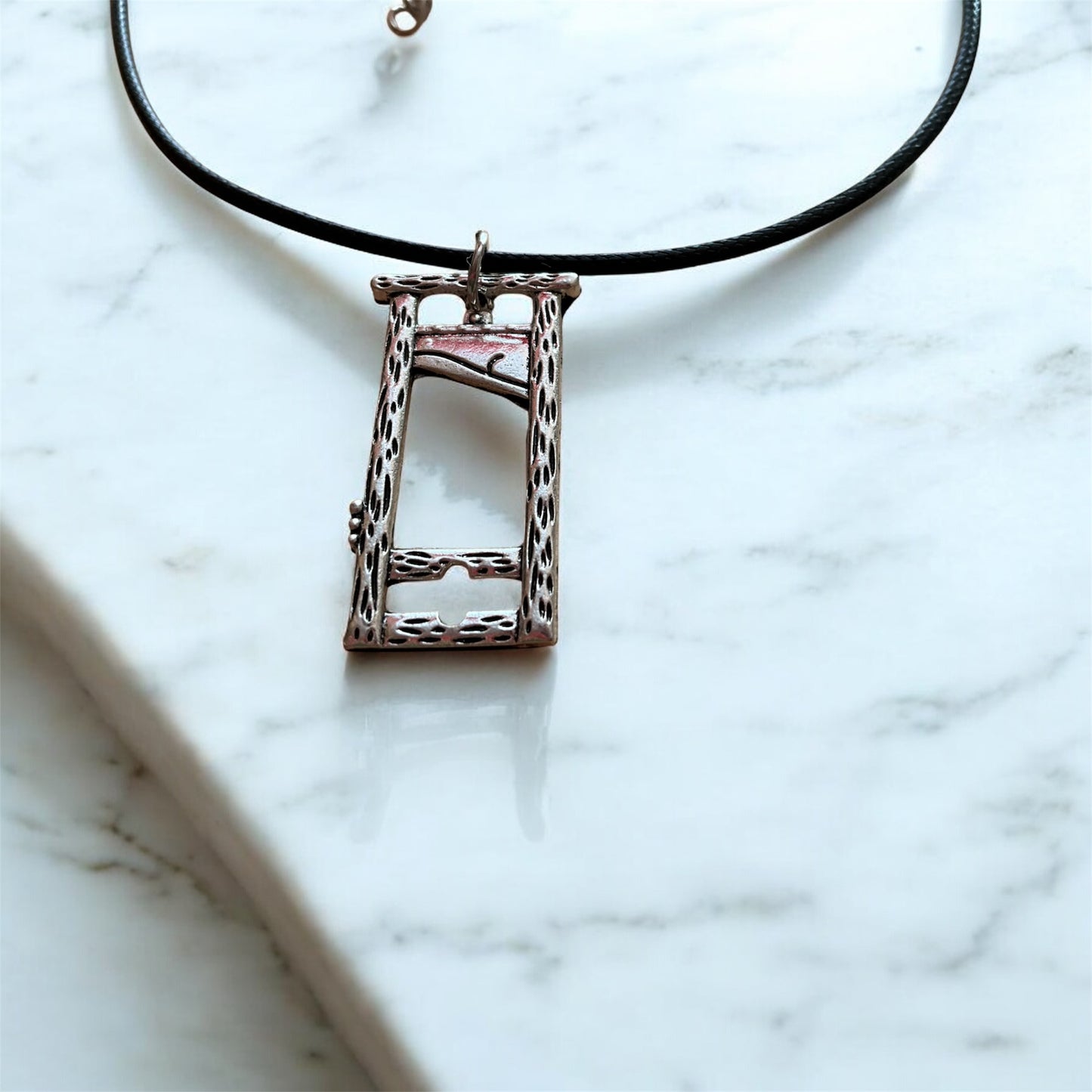 Silver plated guillotine pendant with black necklace