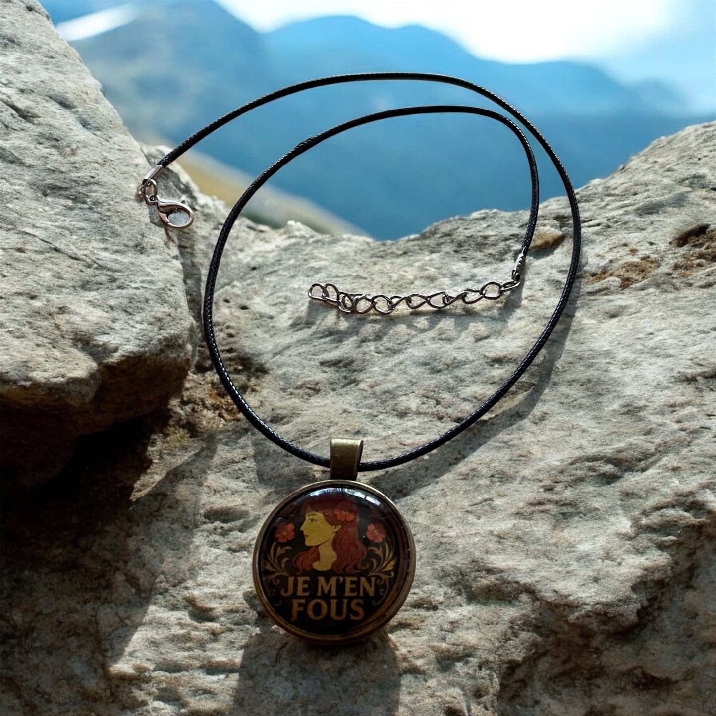 Cheeky “Je m’en fous” pendant with black cord necklace