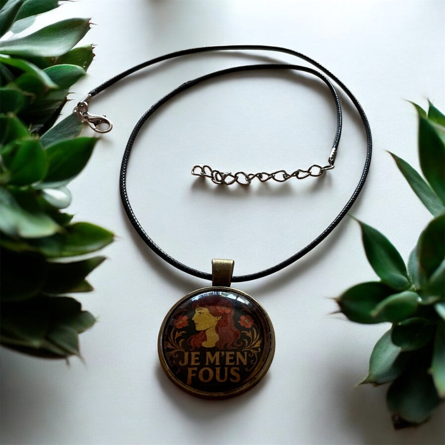 Cheeky “Je m’en fous” pendant with black cord necklace