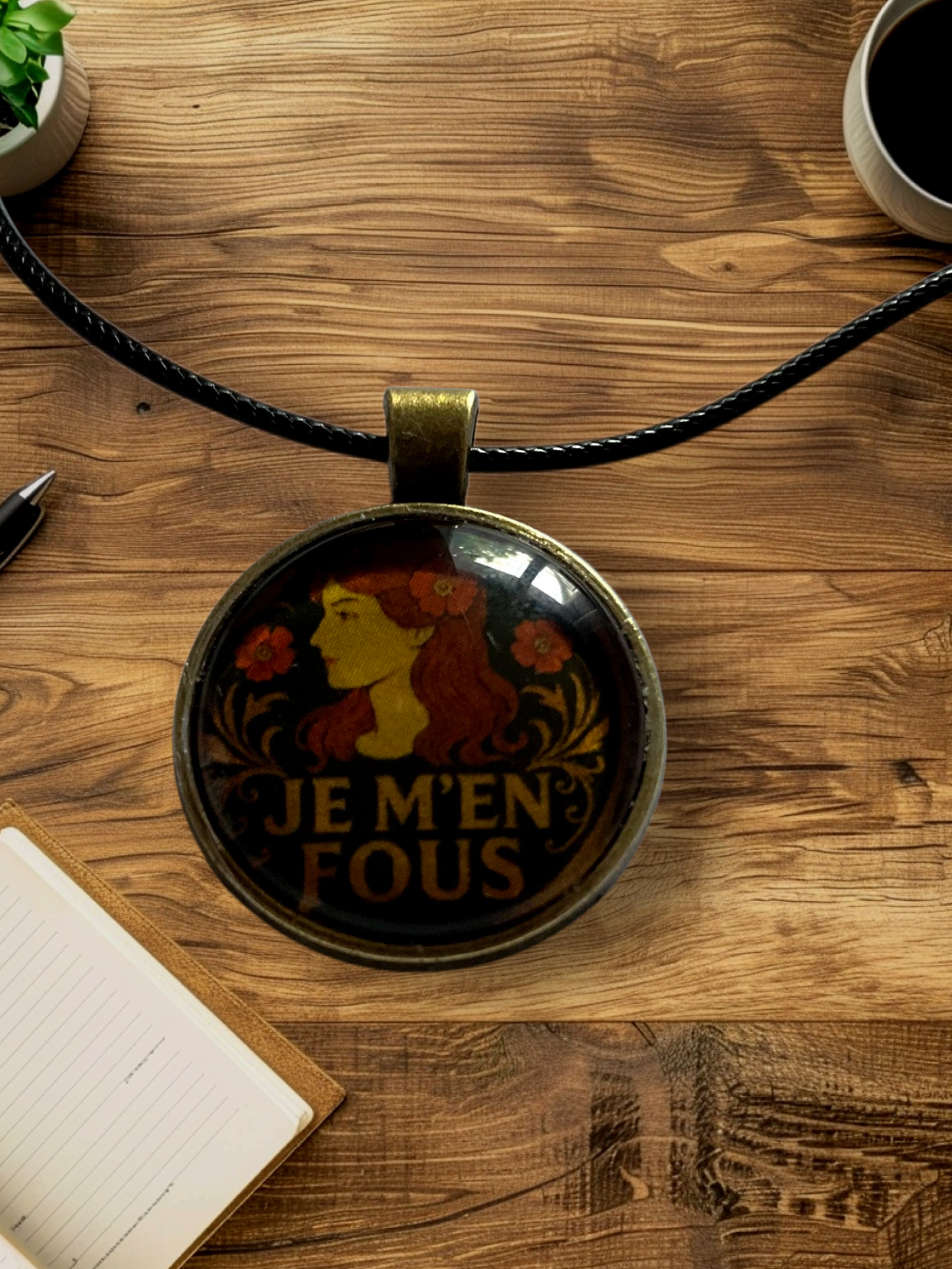 Cheeky “Je m’en fous” pendant with black cord necklace